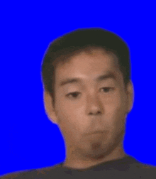 a man is making a funny face with his eyes closed .