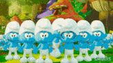 a group of smurfs standing next to each other with the word smurfs above them