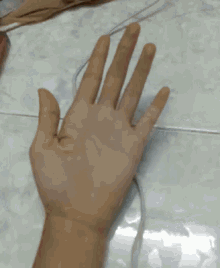 a person 's hand is shown with a ring on it