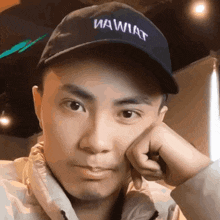 a man wearing a blue hat that says wawhat on it