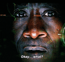 a close up of a man 's face with the words okay what on the bottom right