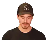 a man wearing a hat and a black shirt that says coach josh