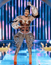 a woman in a costume is holding a violin and a microphone on a stage