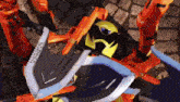 a robot with a shield and a sword is laying on a cobblestone street