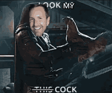 a man is holding a chicken with the words " look my this cock " on the bottom