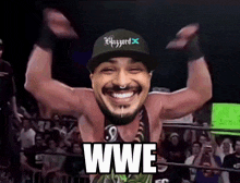 a man in a wrestling ring with the word wwe on his chest