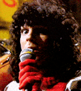 a close up of a woman holding a microphone