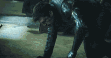 a man in a superhero costume is crawling on the ground