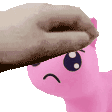 a person is petting a pink stuffed animal on its head .