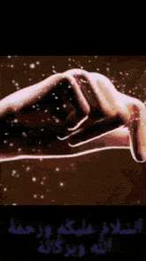 a close up of a person 's hand with sparks flying out of it
