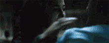 a man and woman are kissing in the dark in a dark room .