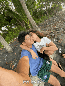 a man kissing a woman on the cheek while wearing a t-shirt that says amanda