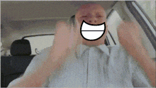 a man in a car has a cartoon face on his face