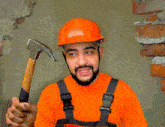 a man wearing an orange hard hat and overalls is holding a hammer