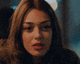 a close up of a woman 's face with long hair