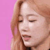 a close up of a woman eating a piece of food .