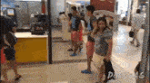 a man and a woman are standing in front of a mcdonald 's restaurant .