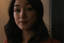a close up of a woman 's face with a slight smile on her face