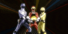 three power rangers are standing next to each other and one of them has the word e.n.k.c on his helmet
