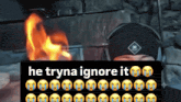 a man wearing headphones stands in front of a fire with the words he tryna ignore it