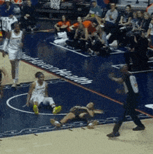 a female basketball player is laying on the floor in front of a written health logo