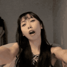 a woman is taking a selfie with her mouth wide open
