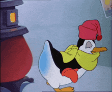 a penguin wearing a red hat and scarf