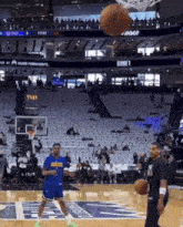 a basketball is being thrown in the air at a basketball court