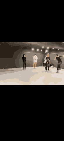 a group of people are dancing in a dance studio in front of a mirror .