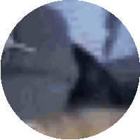 a blurred image of a person in a circle with a blue sky in the background