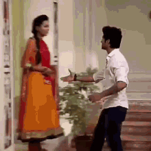 a man and a woman are standing next to each other in front of a door .