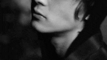 a black and white photo of a woman 's face with a man 's face in the background .