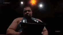 a person is holding a piece of paper with a picture of water on it and the words wwe nxt on the bottom