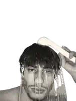 a man is taking a shower with a white shower head