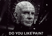 a black and white photo of a man with pins in his head asking if he likes pain .