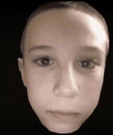 a close up of a child 's face against a black background