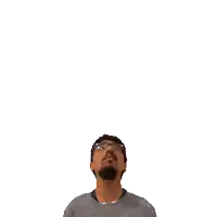 a man with glasses looks up at a green cross on his head