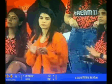 a woman wearing a shirt that says dream11 stands in a crowd