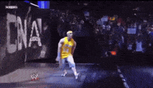 a man in a yellow jersey with the number 50 on it is dancing