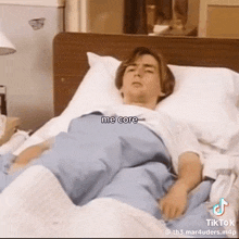 a man is laying in a hospital bed with the caption me core