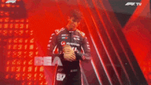 a man in a racing suit says ciao in front of a red background
