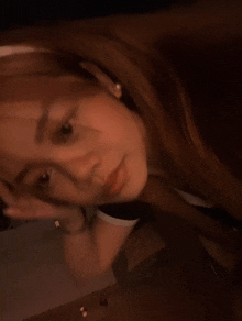 a close up of a woman taking a selfie in front of a mirror .