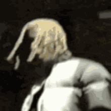 a close up of a person 's back with a white jacket on