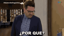 a man wearing glasses and a blue shirt says por que