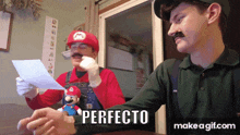 two men dressed up as mario and luigi are sitting at a table with the word perfecto written on the bottom