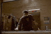 a man is jumping over a window in front of a sign that reads store