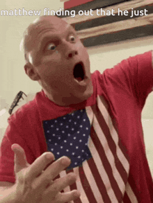 a man in an american flag shirt is making a surprised face
