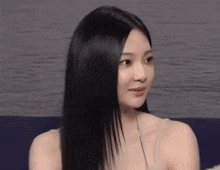 a close up of a woman 's face with long black hair