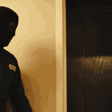a man wearing a mask has a patch on his sleeve that says ' california ' on it
