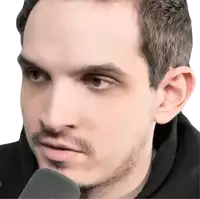 a close up of a man 's face with a microphone in front of him